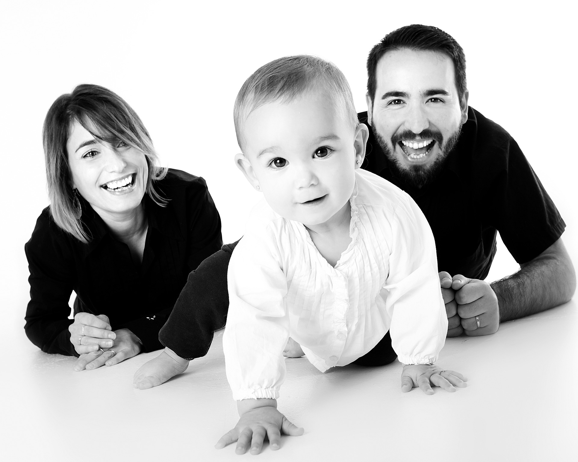 Grey scale image of Baby crawling and Parents watching