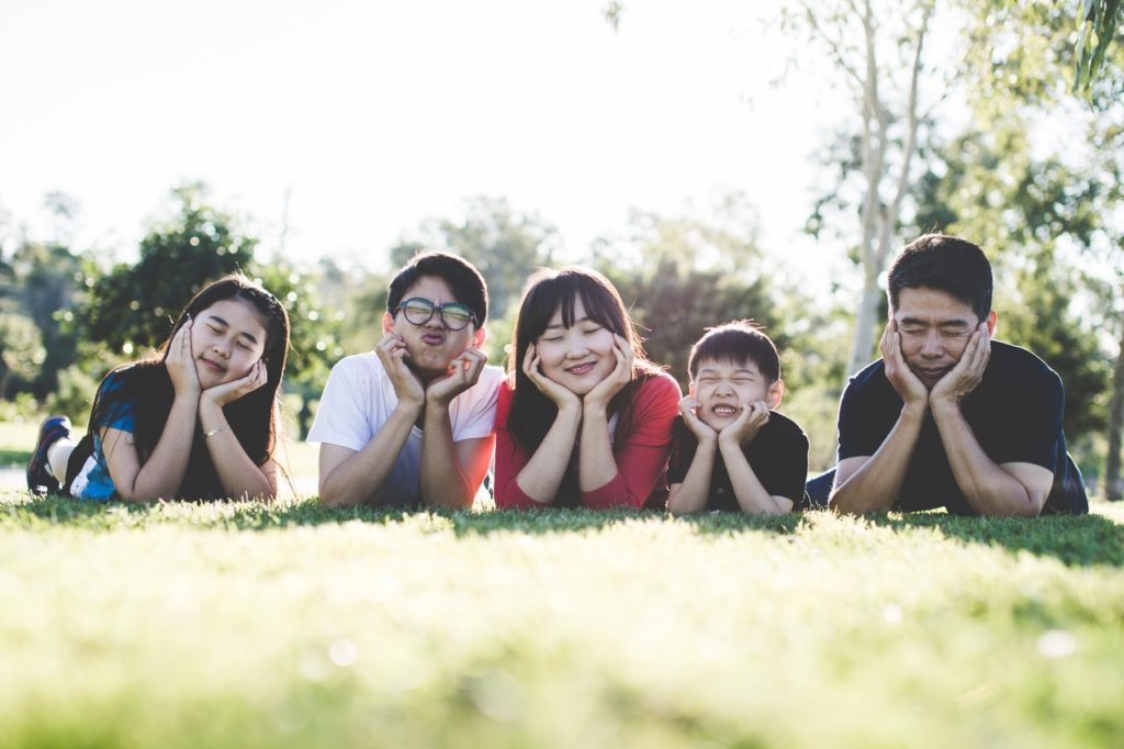 cute family photo in a park; Benefits of Park - helps protect innocence