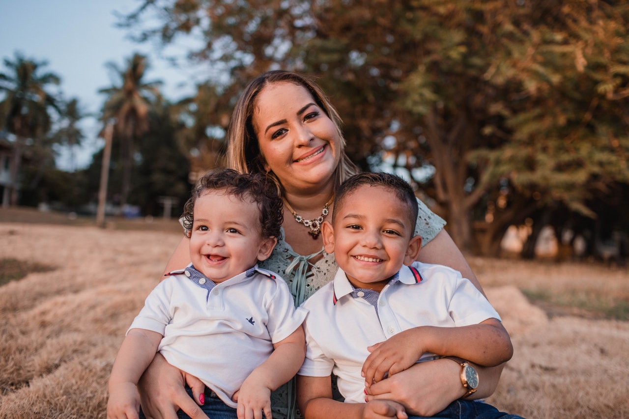 two boys on mothers lap positive parenting tips