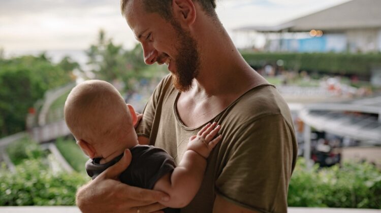 father helping with the baby