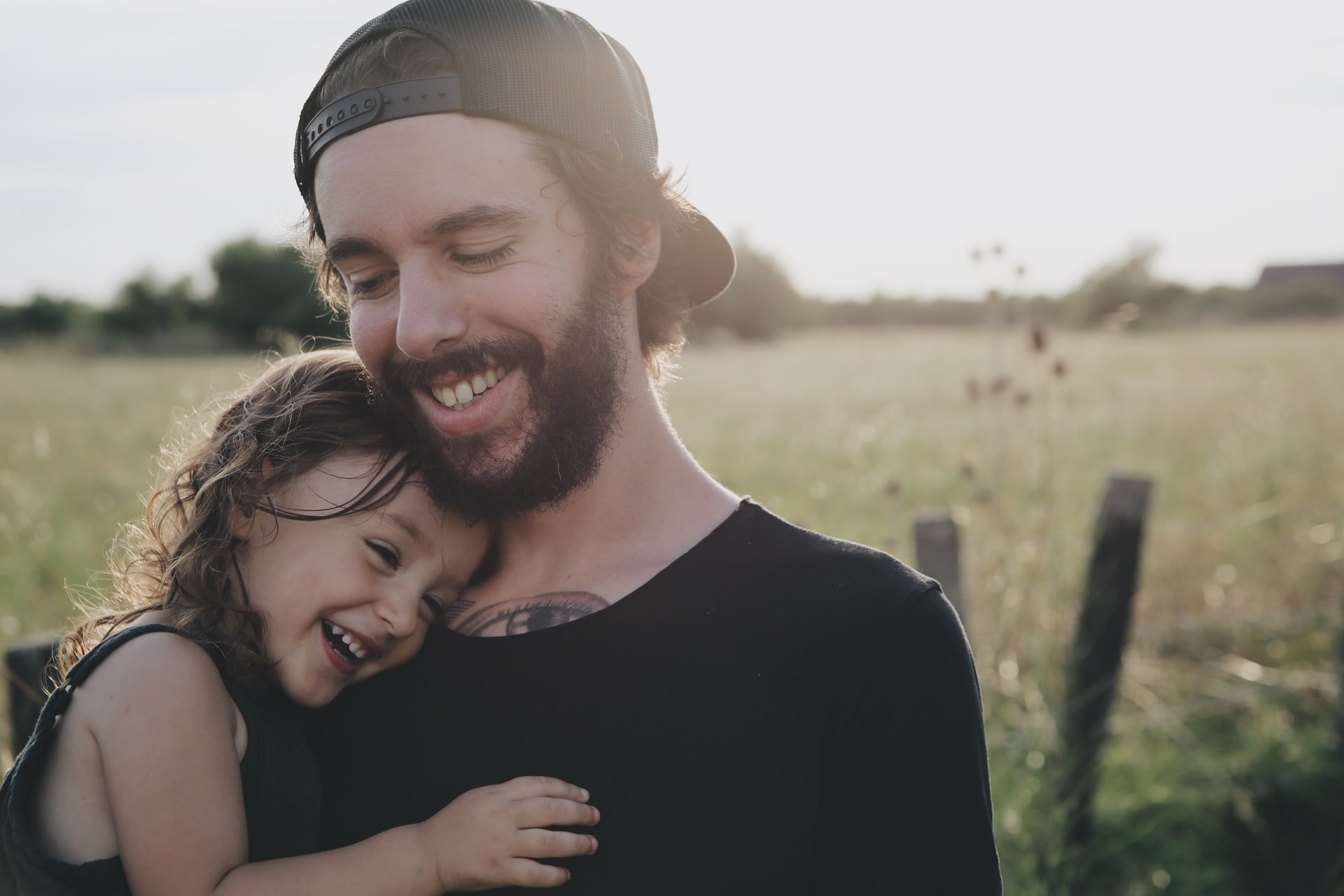 father hugging a child; hug your child often